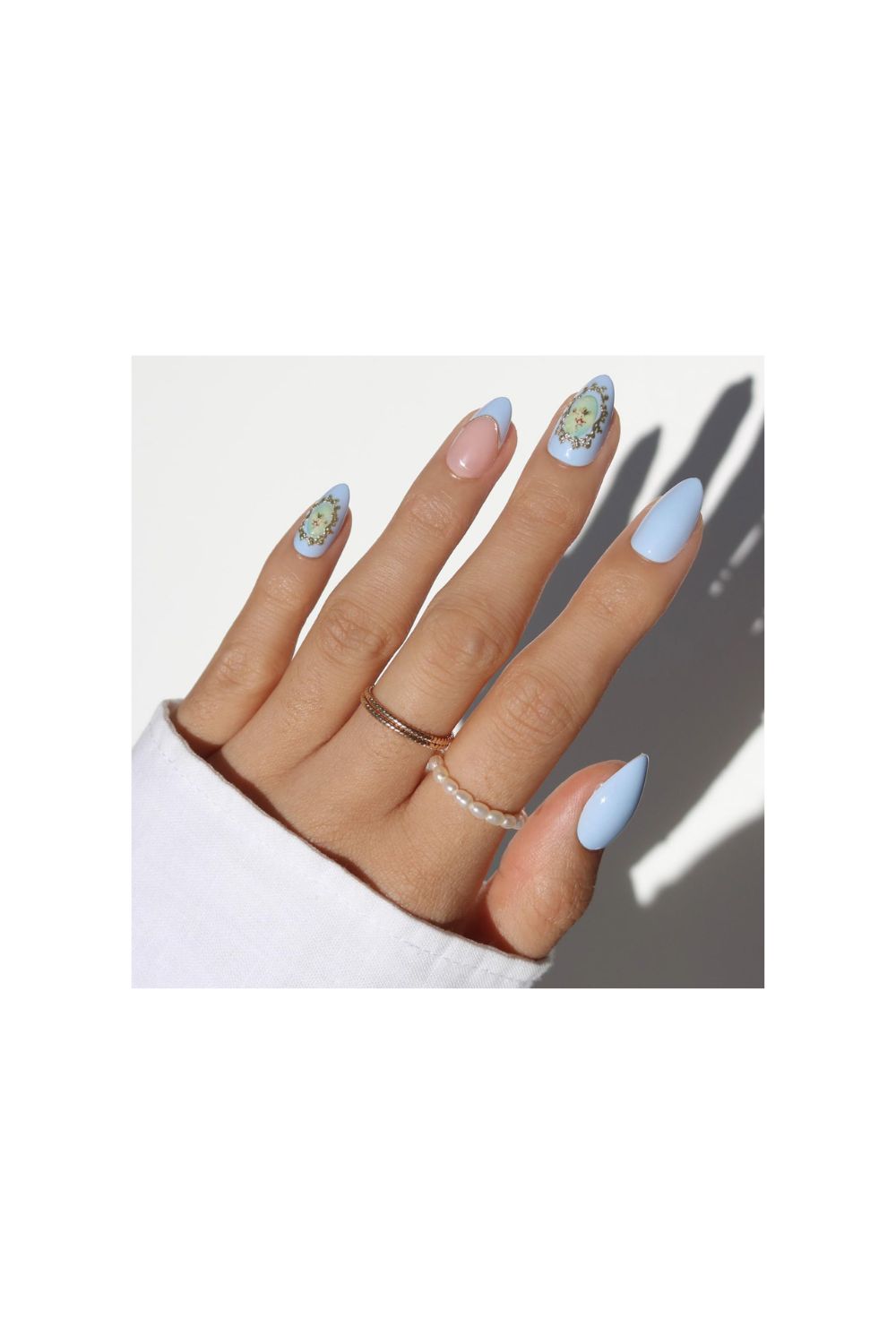 Glamnetic blue spring nails with angel cherub graphics and 3D gold details