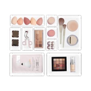 Vtopmart clear acrylic makeup drawer organizer trays neatly arranged with cosmetics inside a vanity drawer